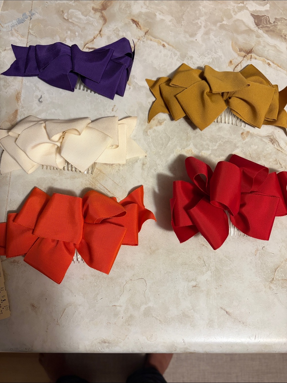 Vintage ribbon hair bows in purple, gold, cream, orange, and red.